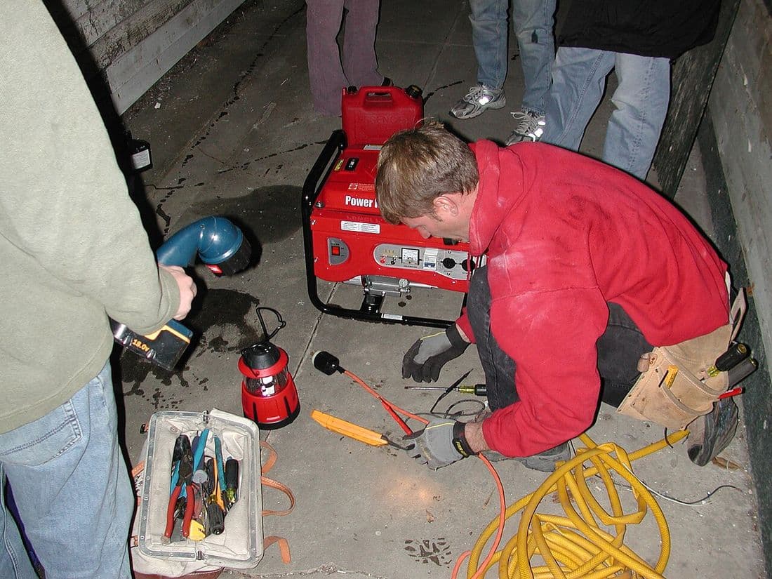 Electrician connecting a home's electrical panel and wiring during an installation.